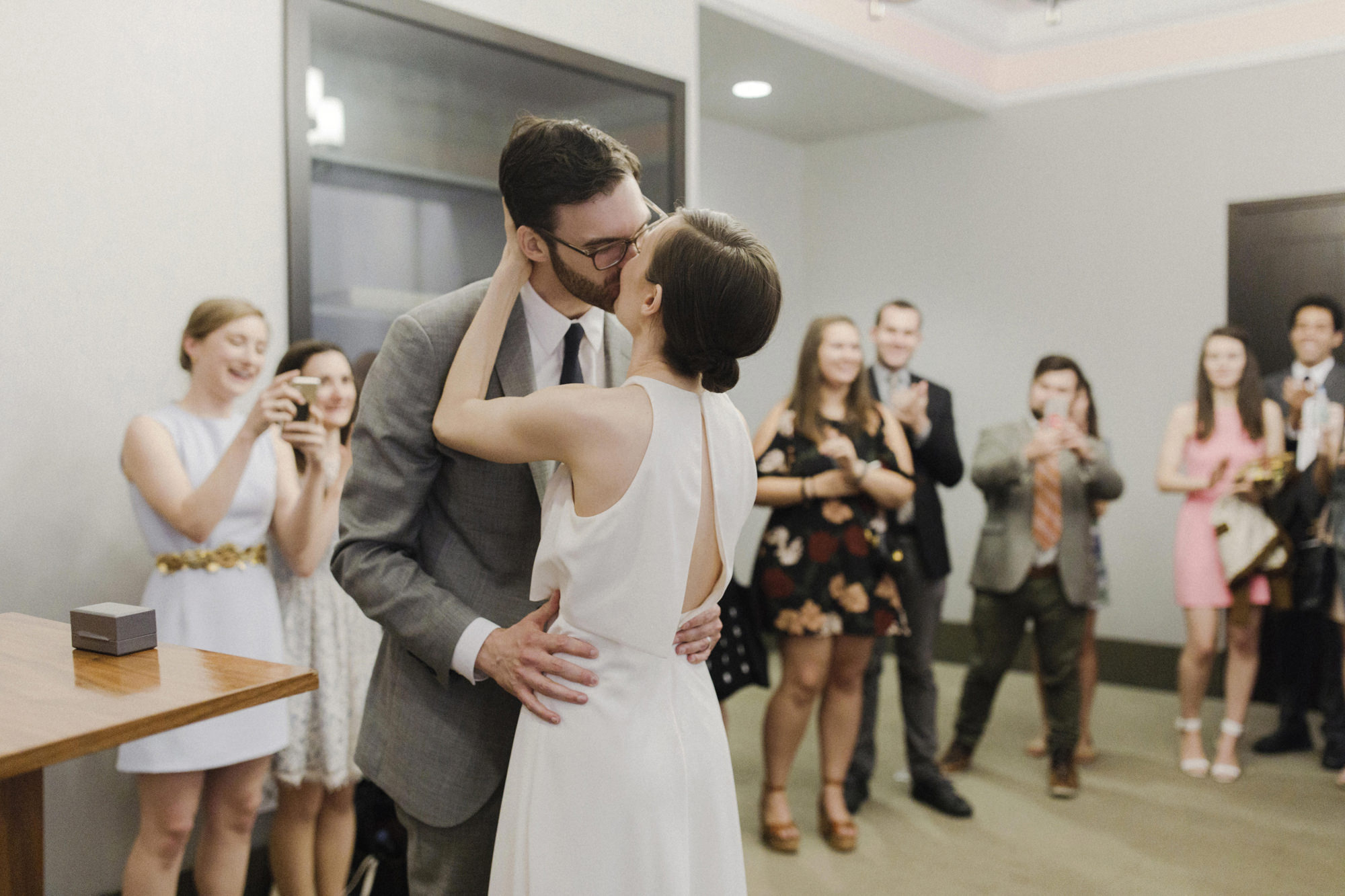 Bride and groom kiss at wedding ceremony at City Hall