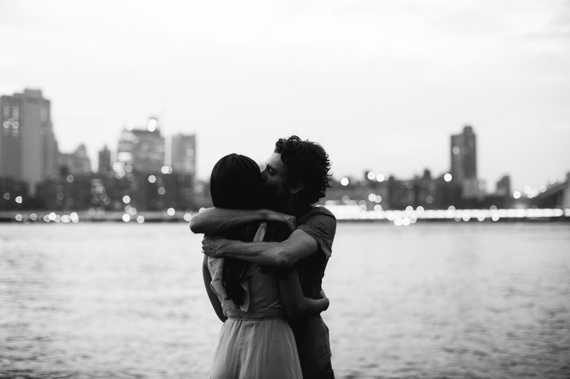 Couple at twilight on east river in brooklyn