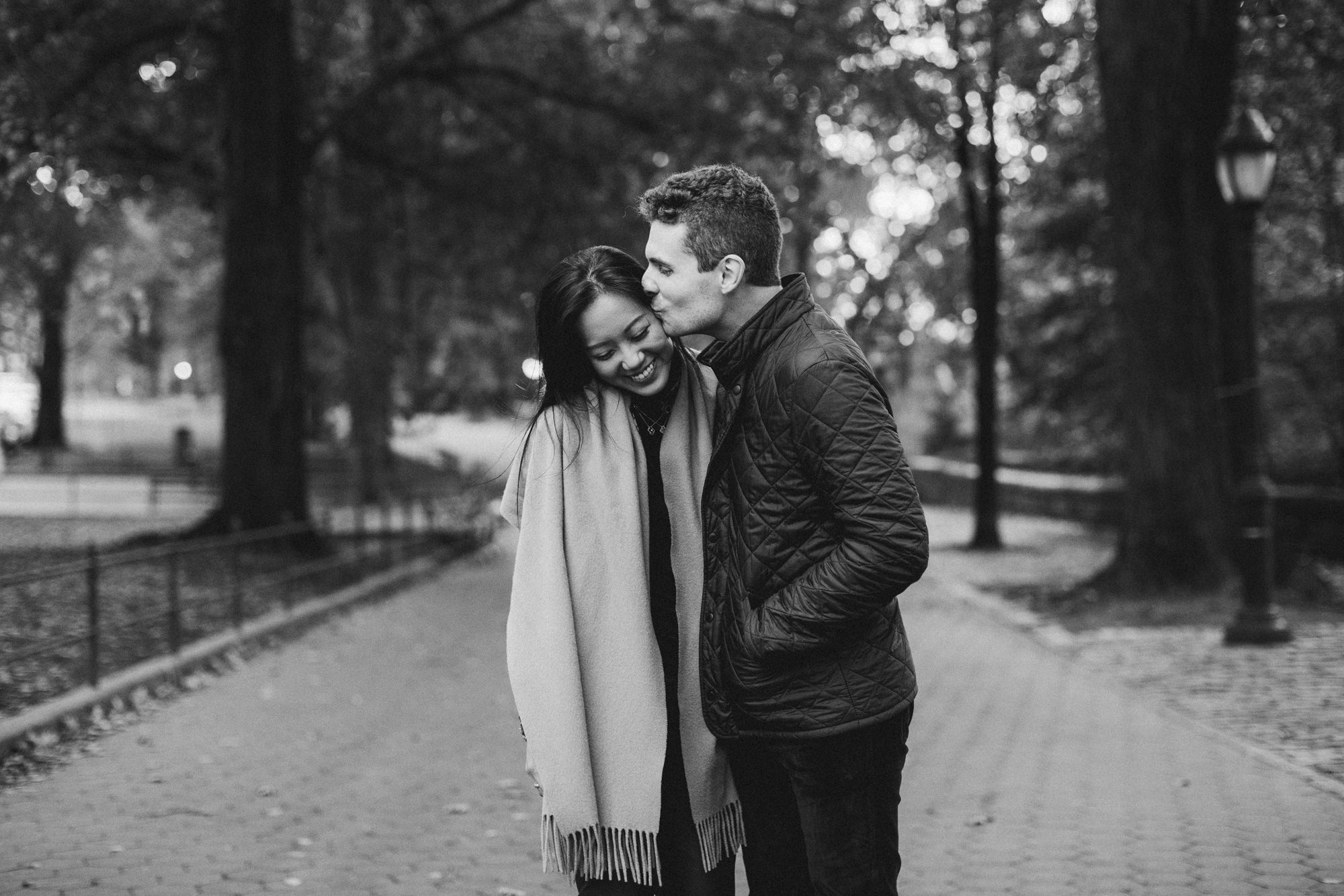 Man kissing woman at Riverside Park