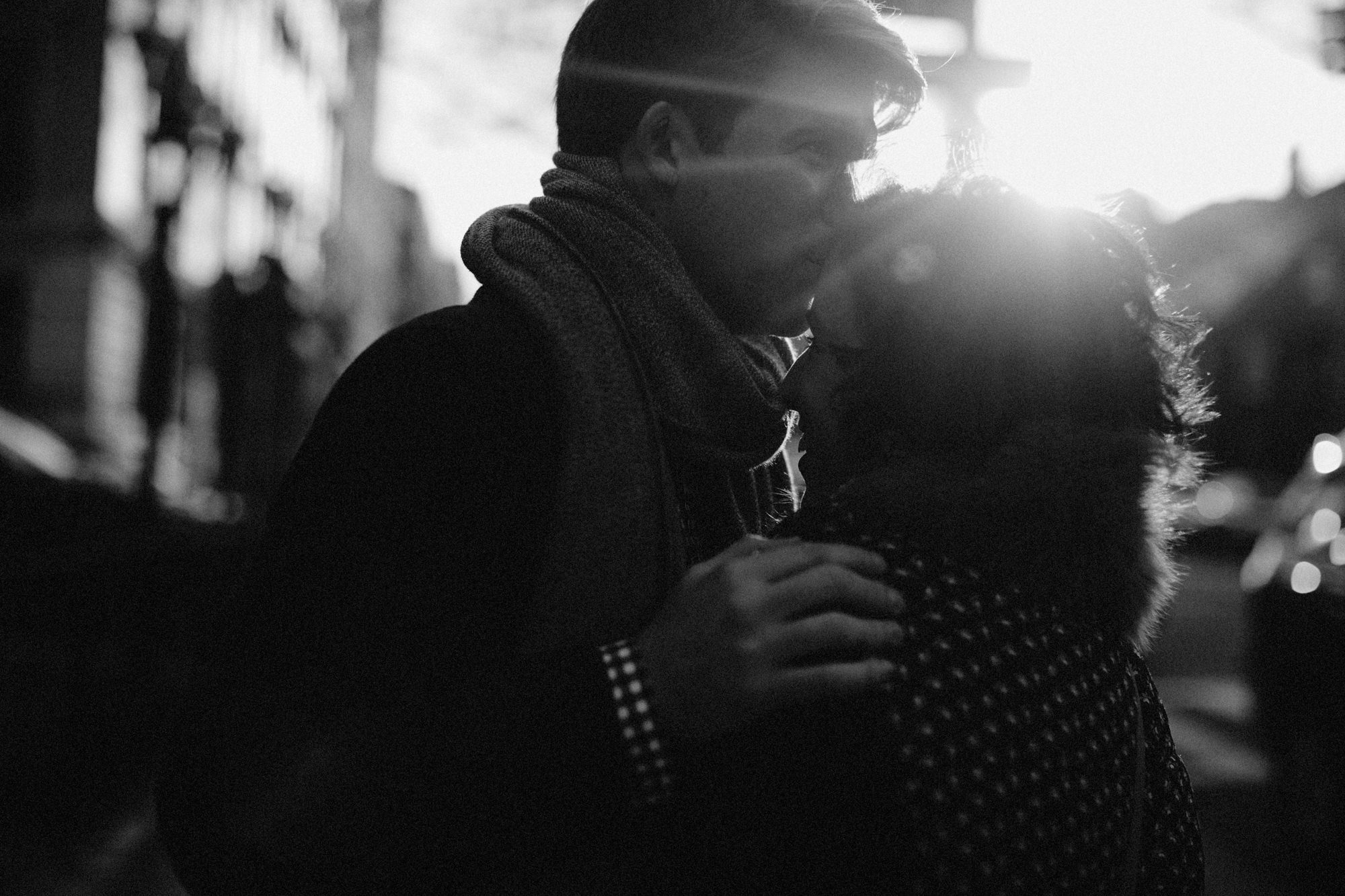 Man kissing woman on forehead at sunset