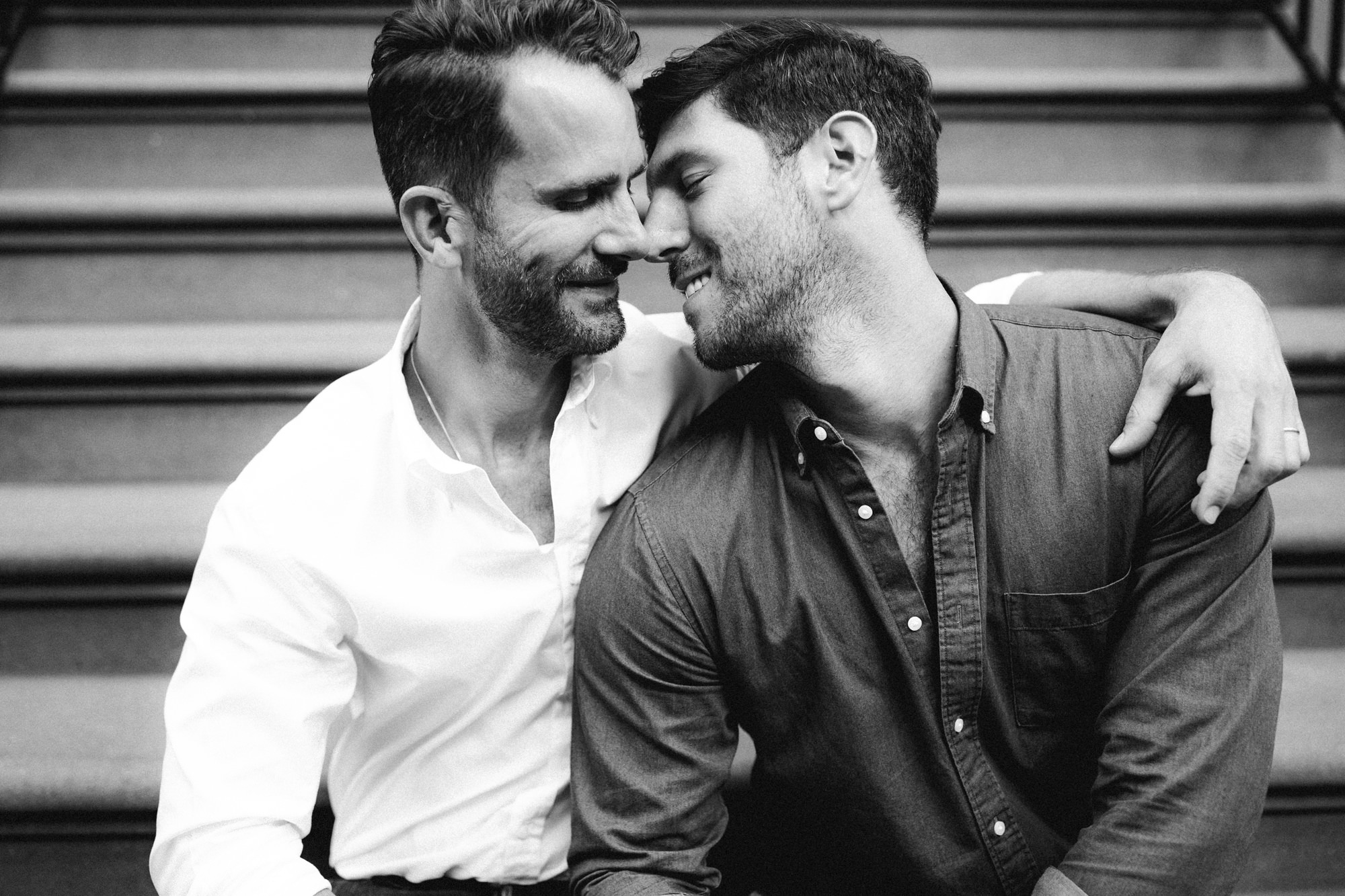 Couple kissing on brownstone stairs