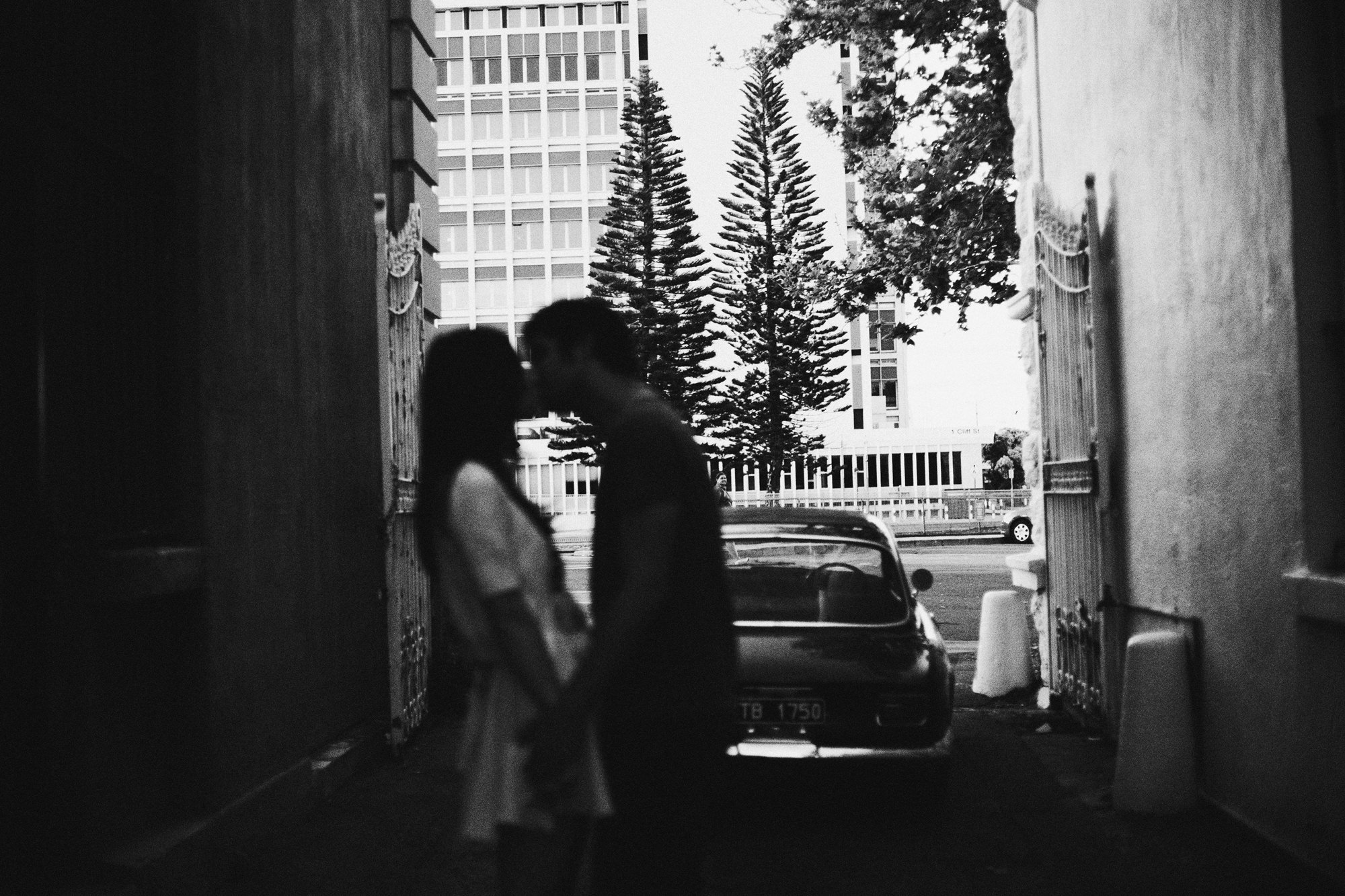 couple kissing with vintage car in background