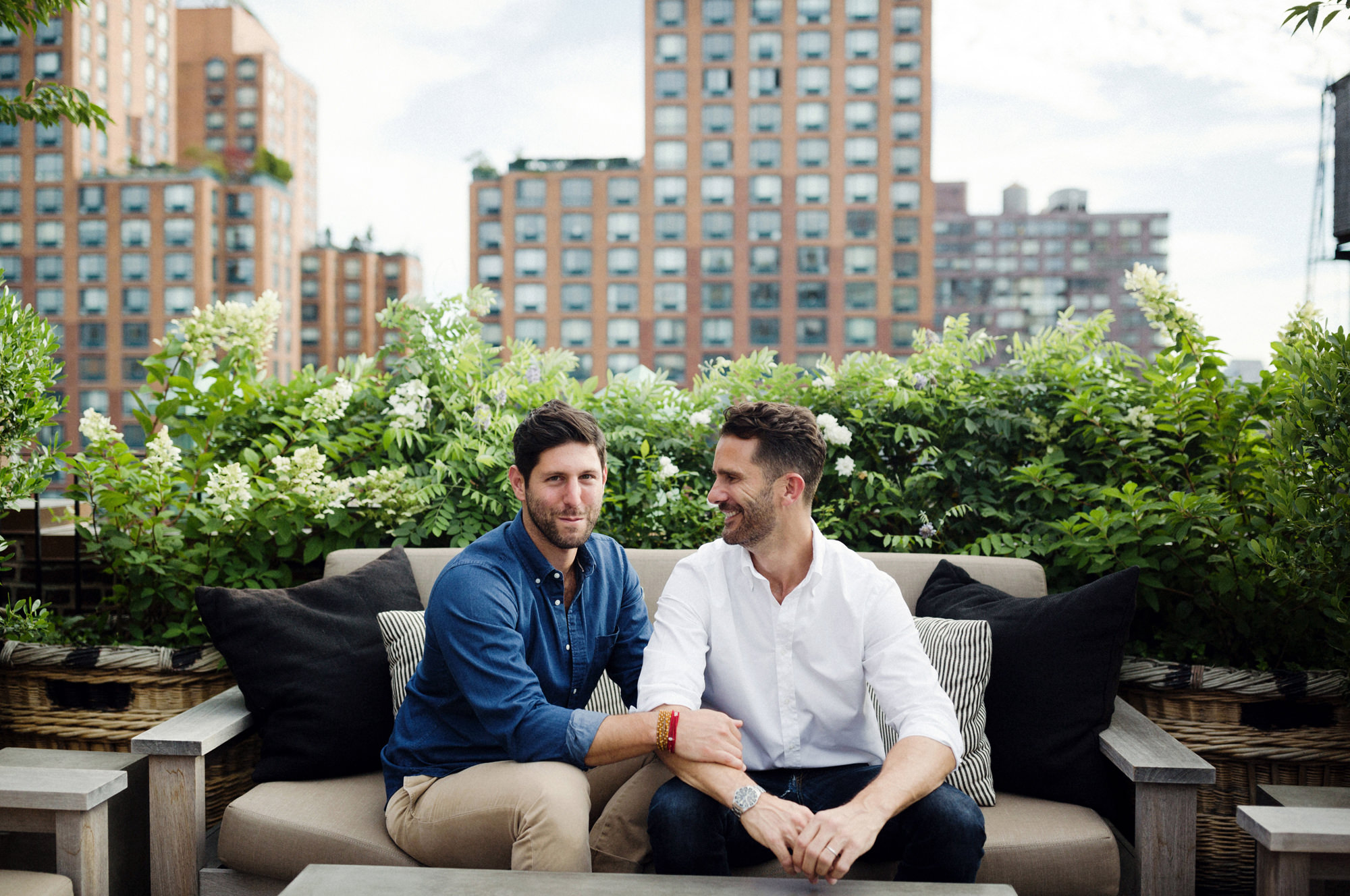 Couple sitting on rooftop chairs