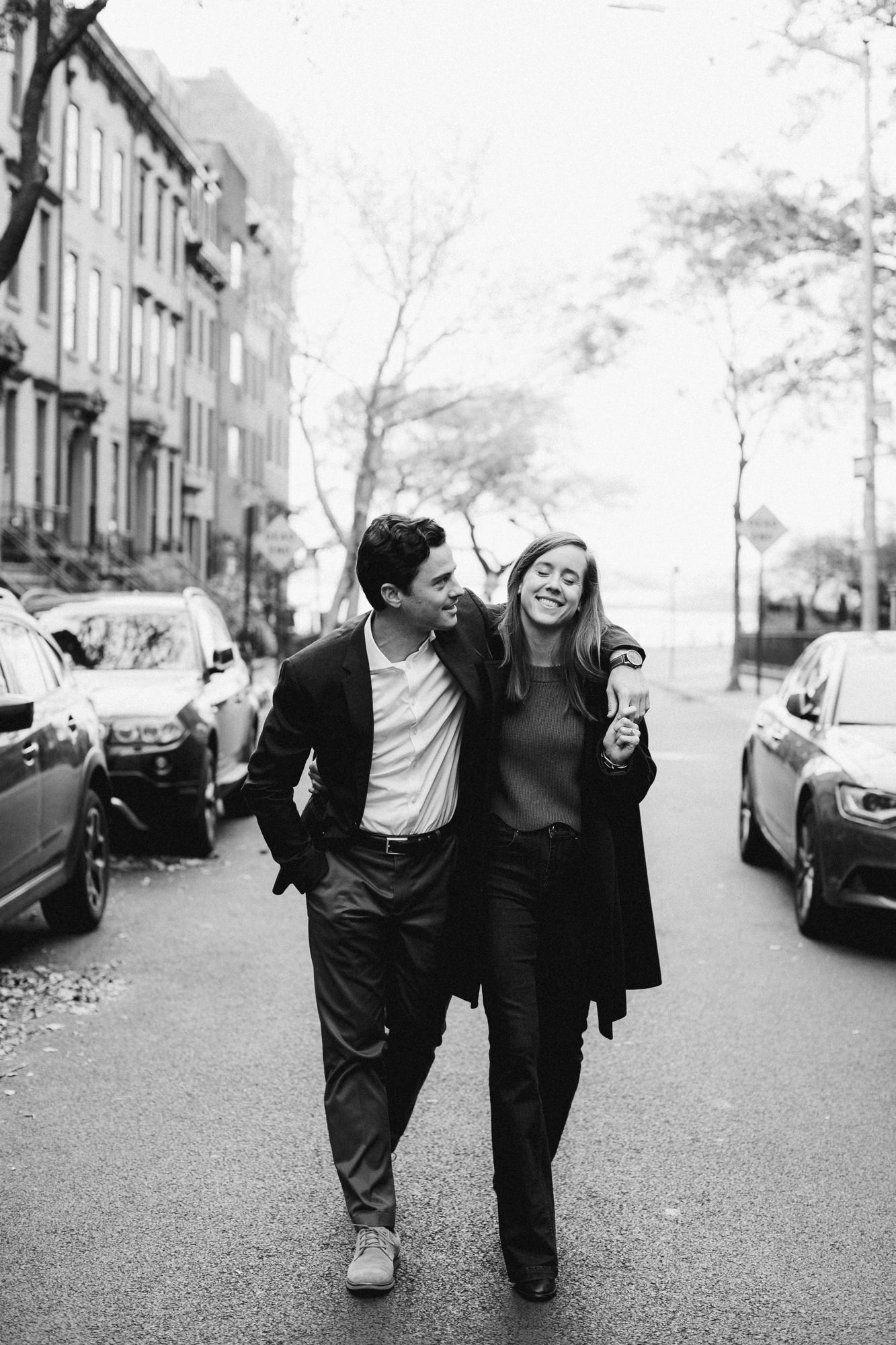 Black and white portrait of couple walking down street