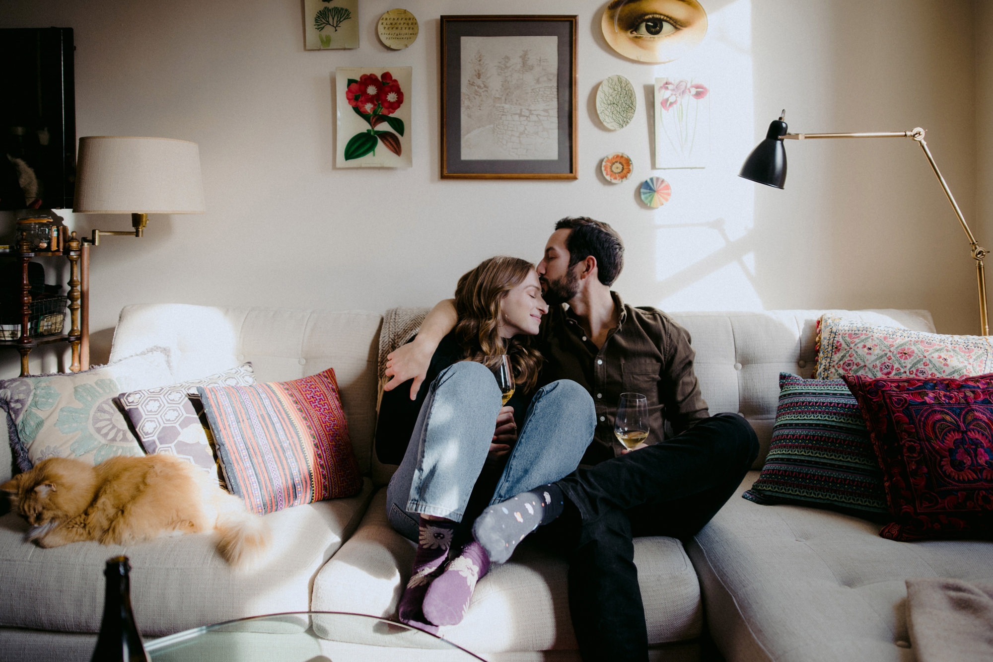 Couple cuddling on couch at home