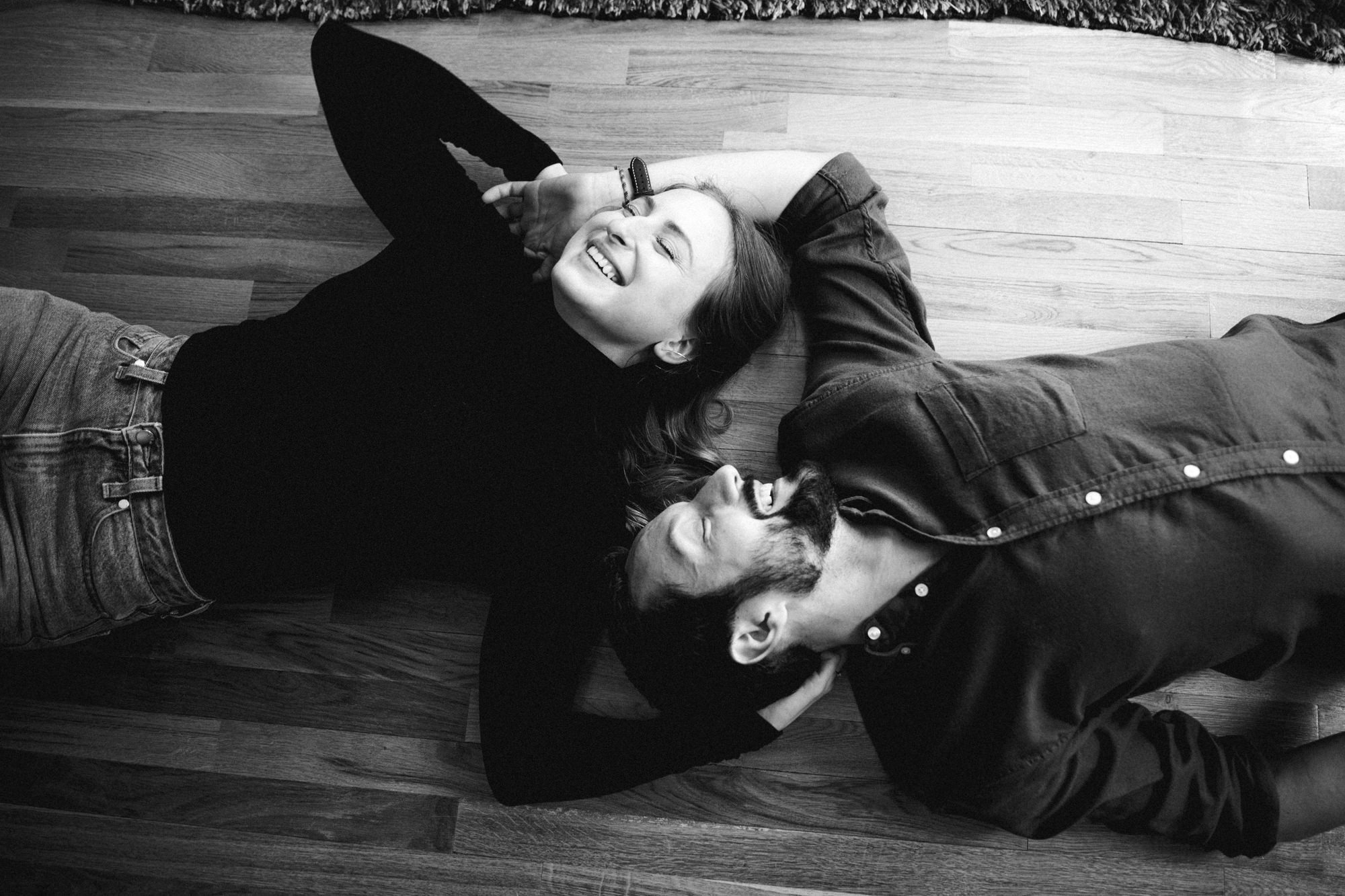 Couple laying on floor laughing