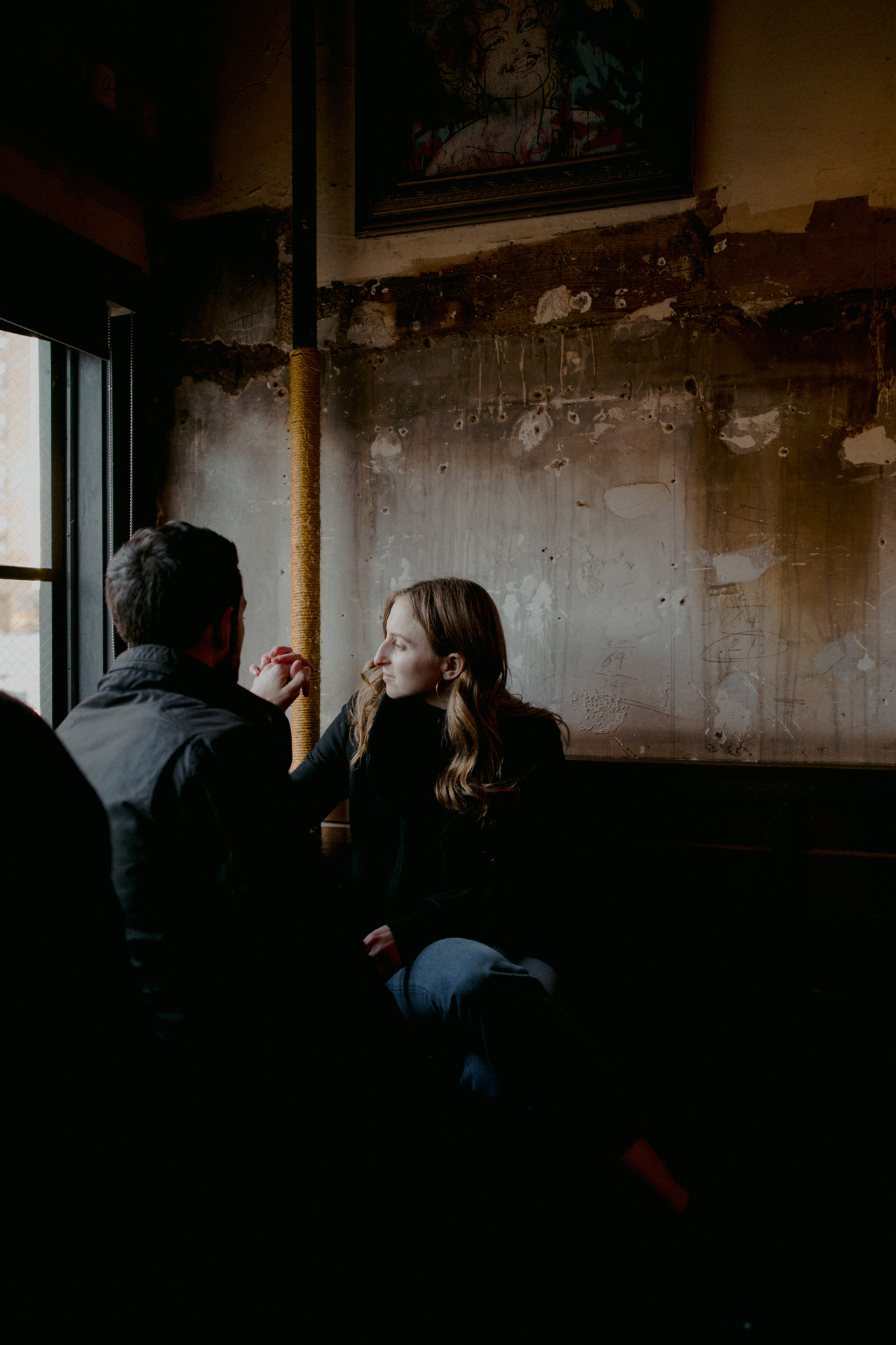 Couple having a drink in bar during engagement shoot