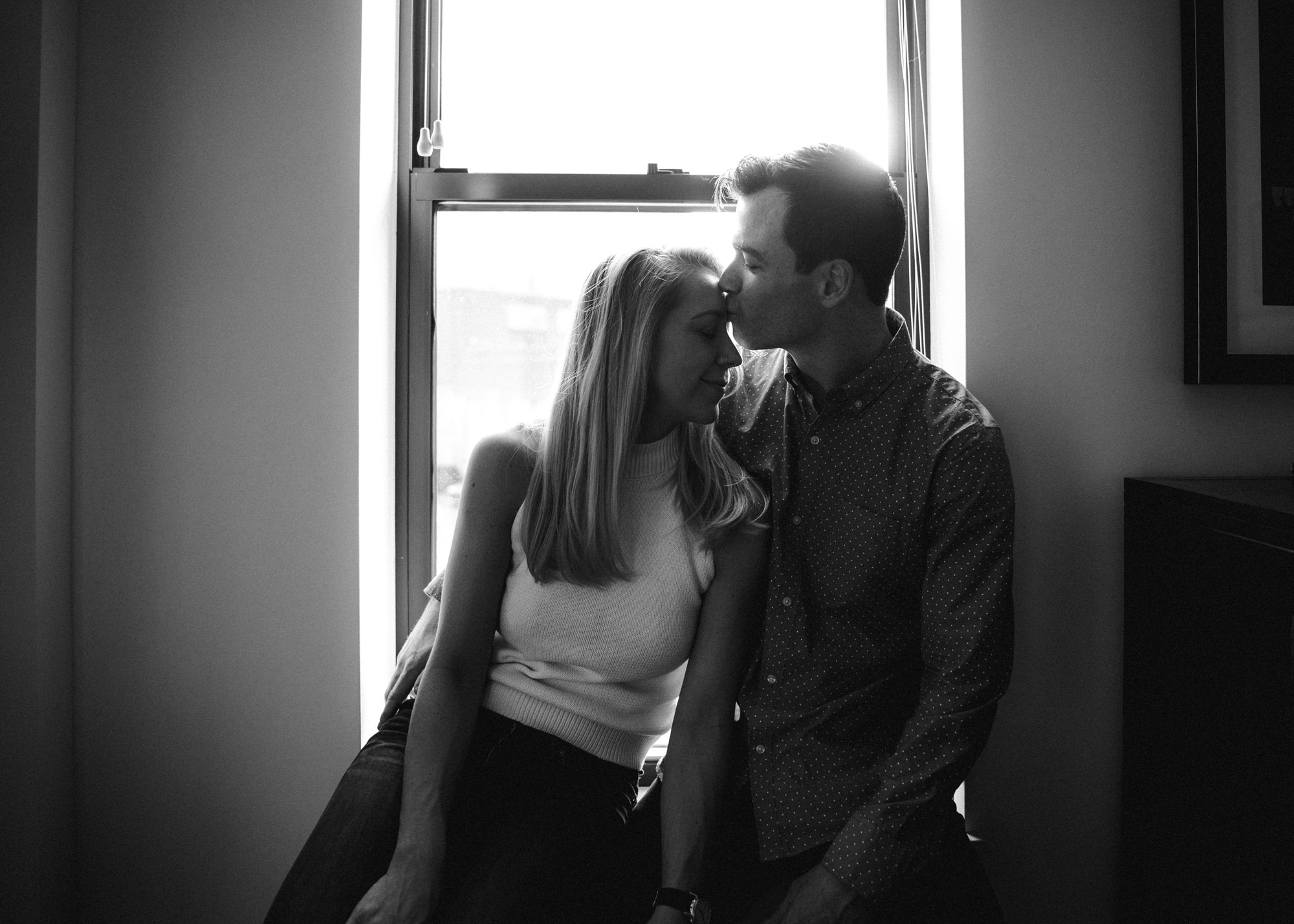 Couple in window at home