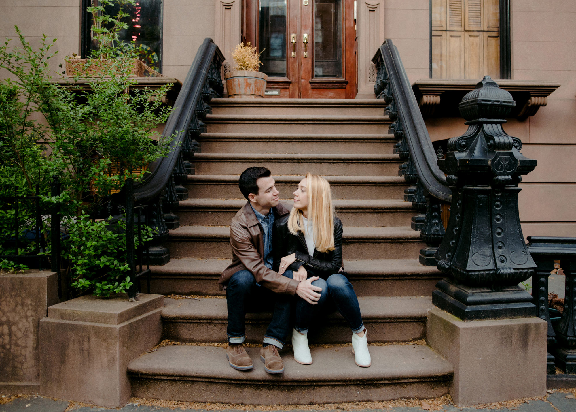 Couple on stoop of brownstone home in Brooklyn